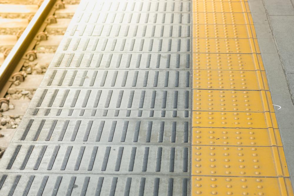 Tactile paving for blind handicap on tiles pathway, walkway for blindness people with train railway