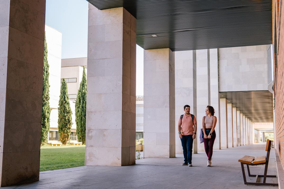 Two Students Walking Around A College Campus