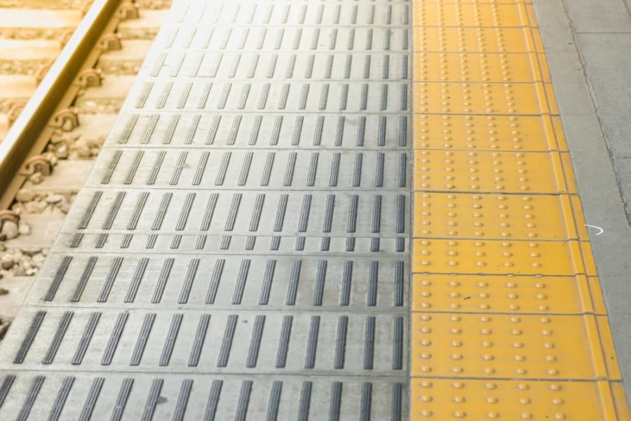 Tactile paving for blind handicap on tiles pathway, walkway for blindness people with train railway