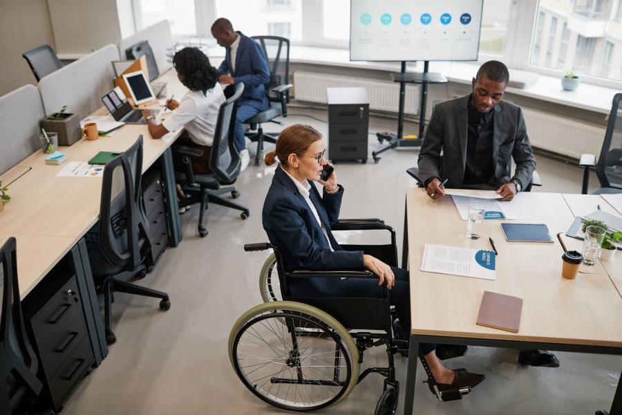 woman using wheelchair in office