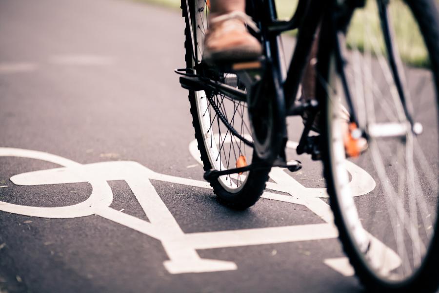 person riding on bike path in the city