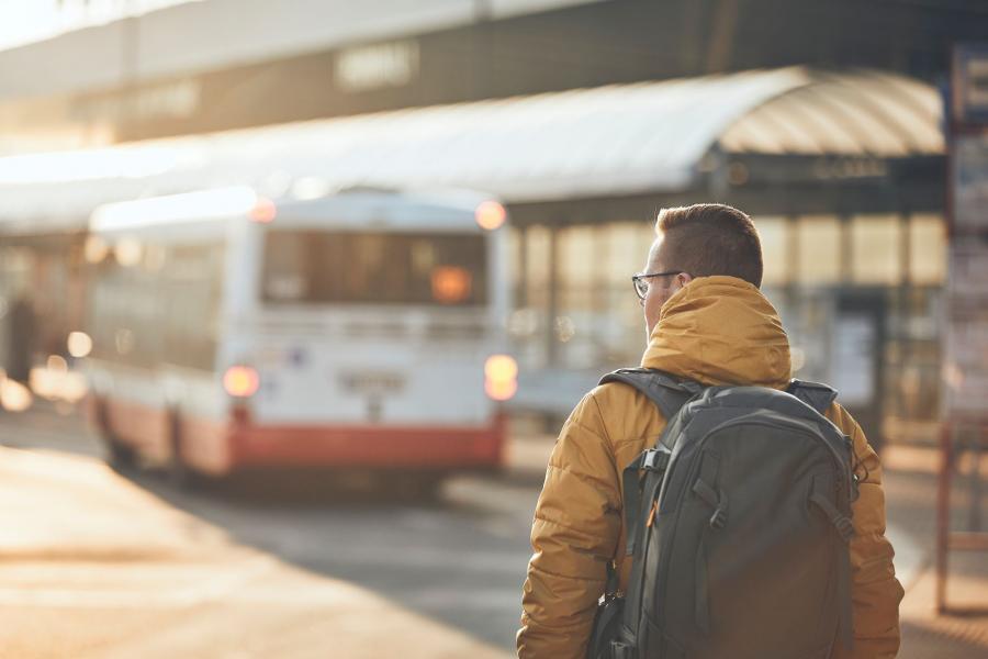 Passenger walking to bus stop