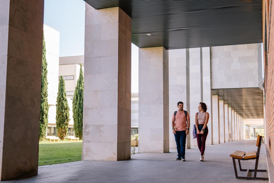 Two Students Walking Around A College Campus