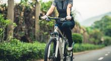 riding a bike on tropical park trail