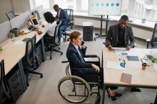 woman using wheelchair in office