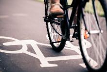 person riding on bike path in the city