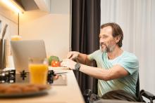 Man in Wheelchair Cooking Dinner in Kitchen